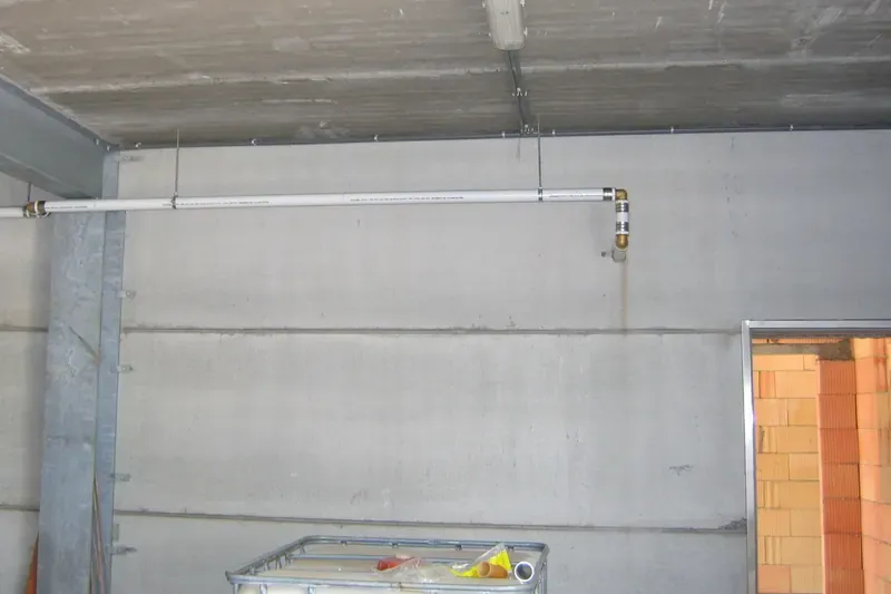 Pressurized water line running along a basement wall