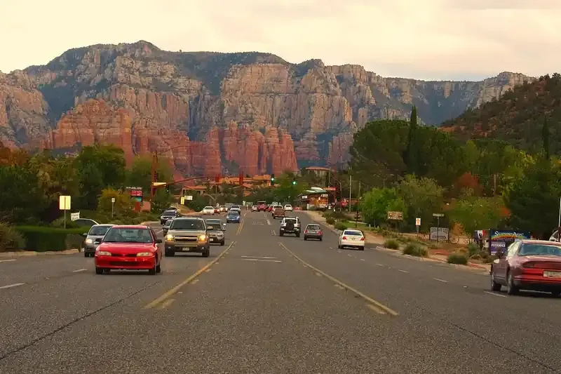 State Route 89A through Sedona with red rock cliffs in the distance