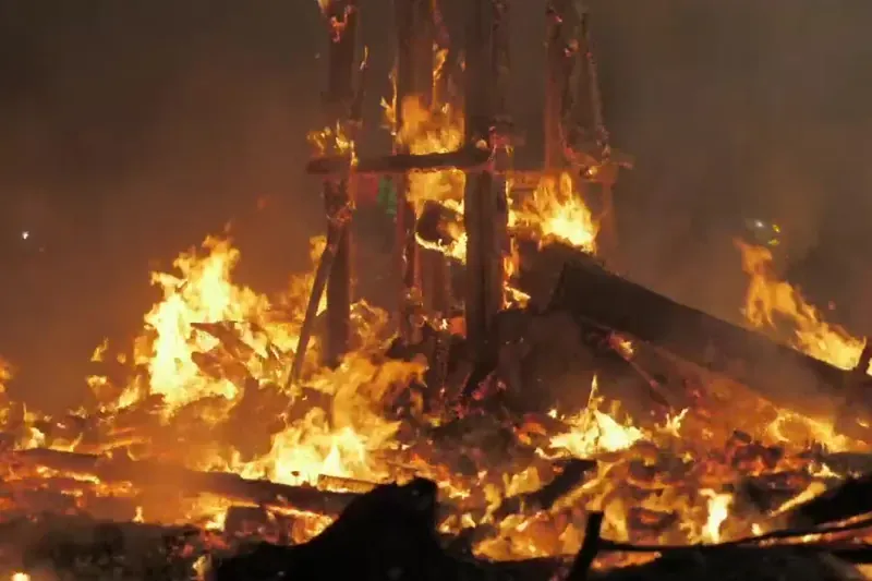 House framing burning at night