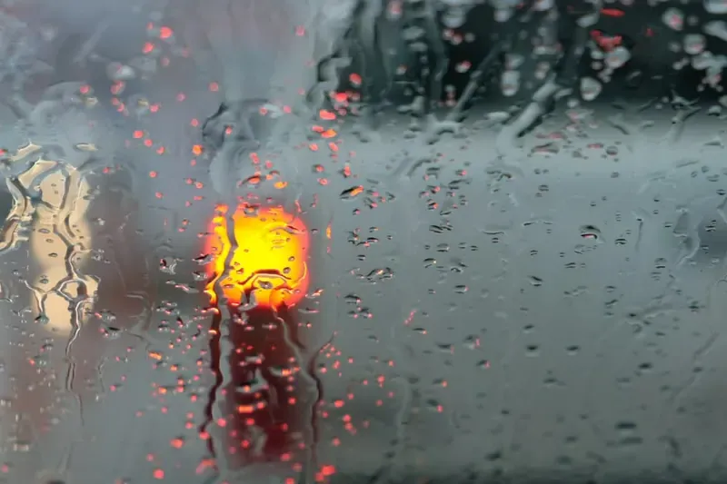 Heavy rain running down a window during a storm