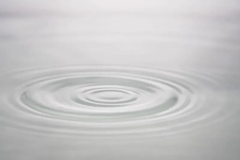Water dripping into a still puddle